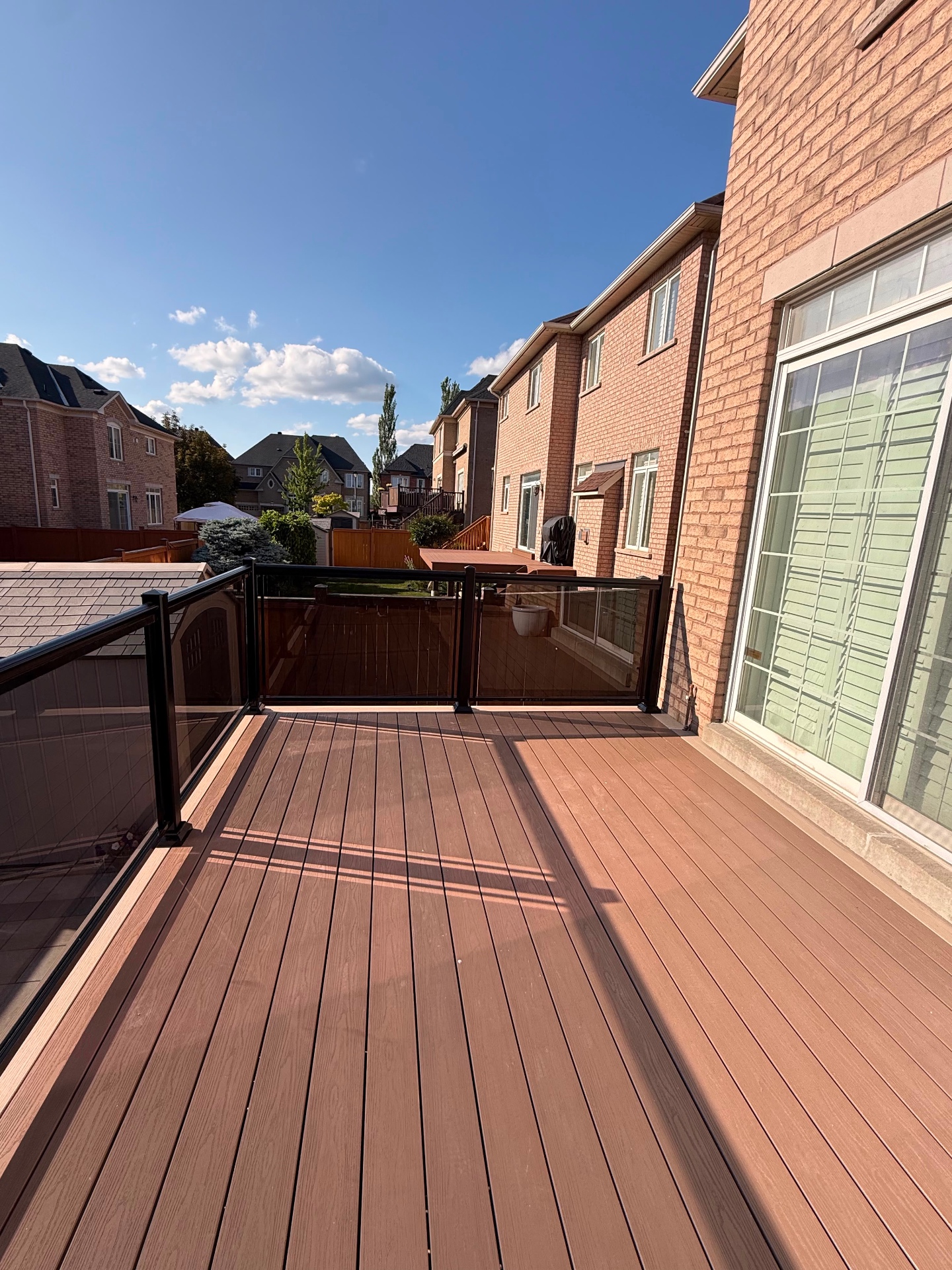 Composite deck framed by glass privacy railing