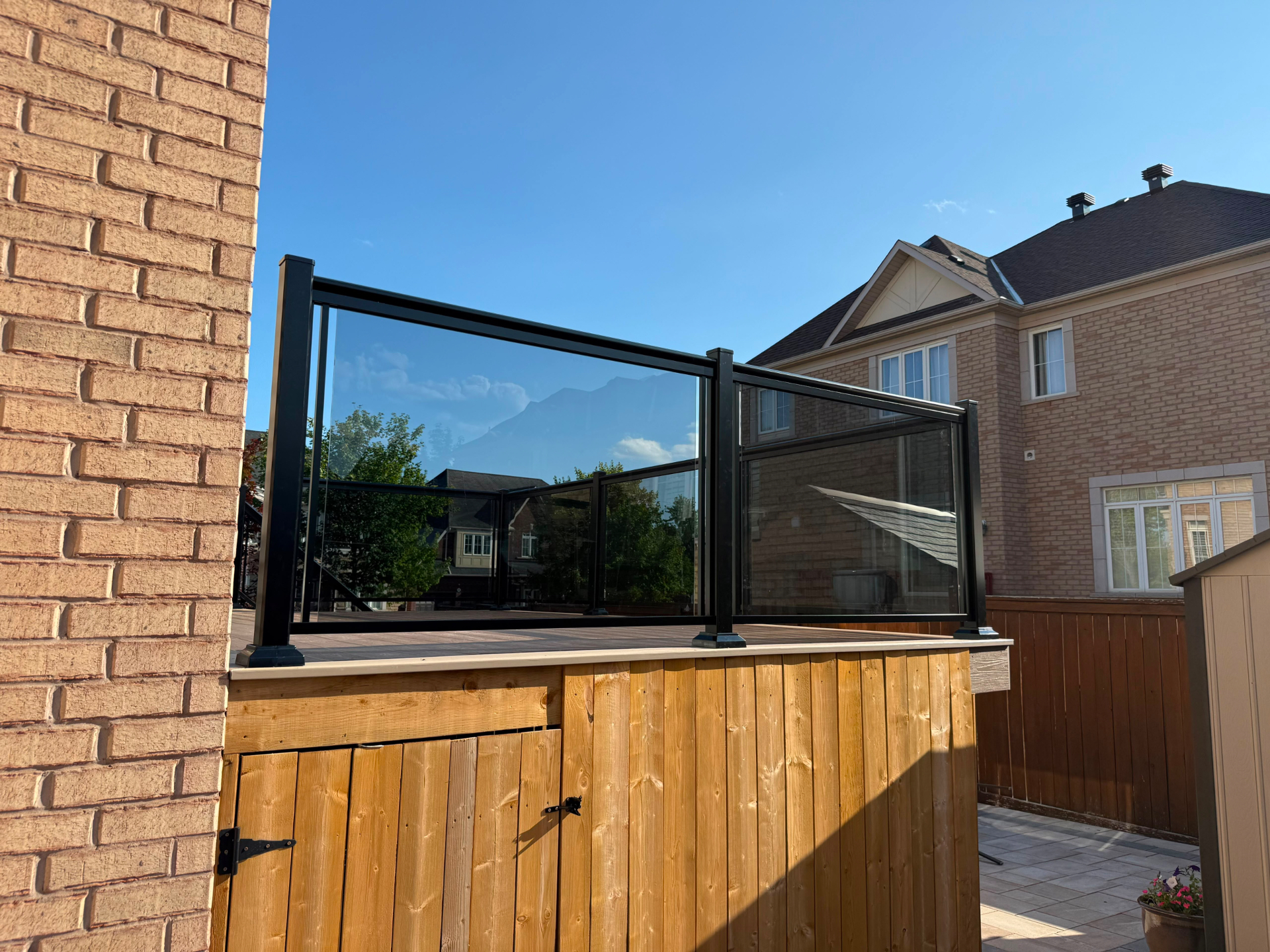 Tinted glass deck railing with black aluminum posts