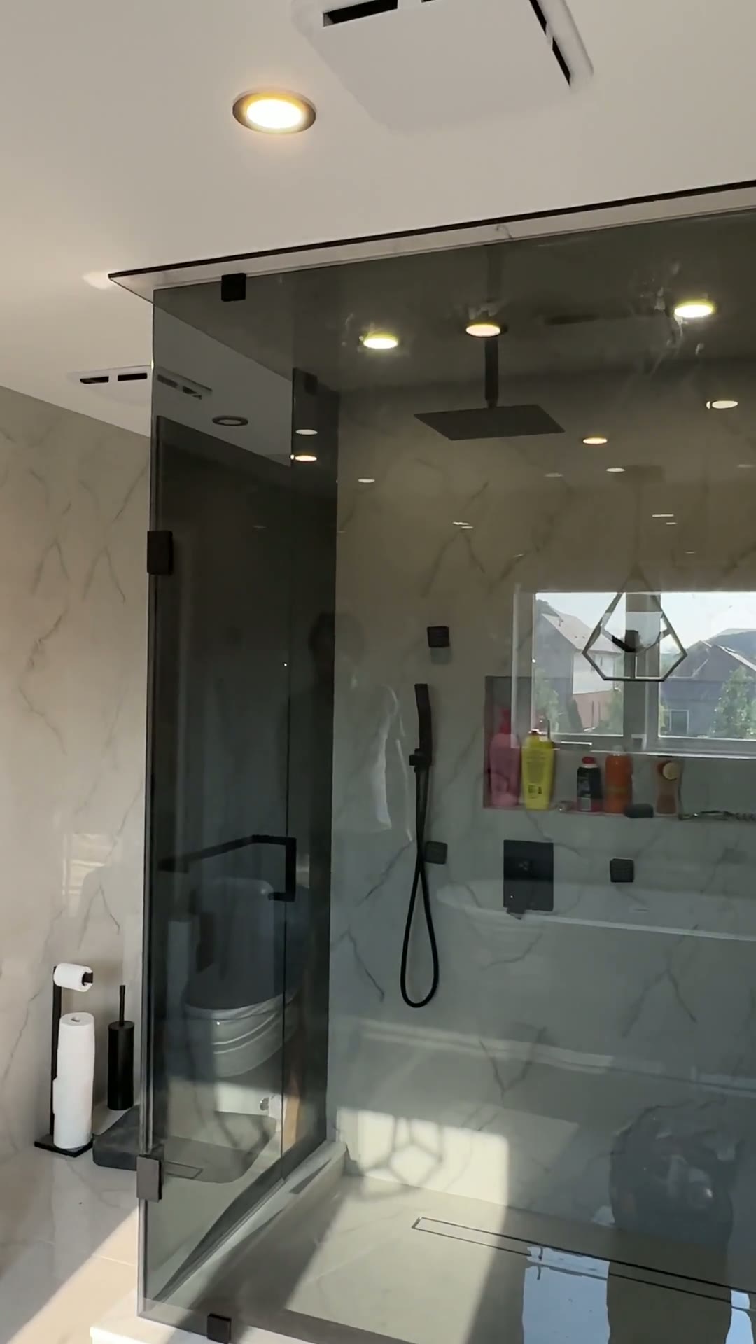 Wide view of the glass steam-shower enclosure and transom