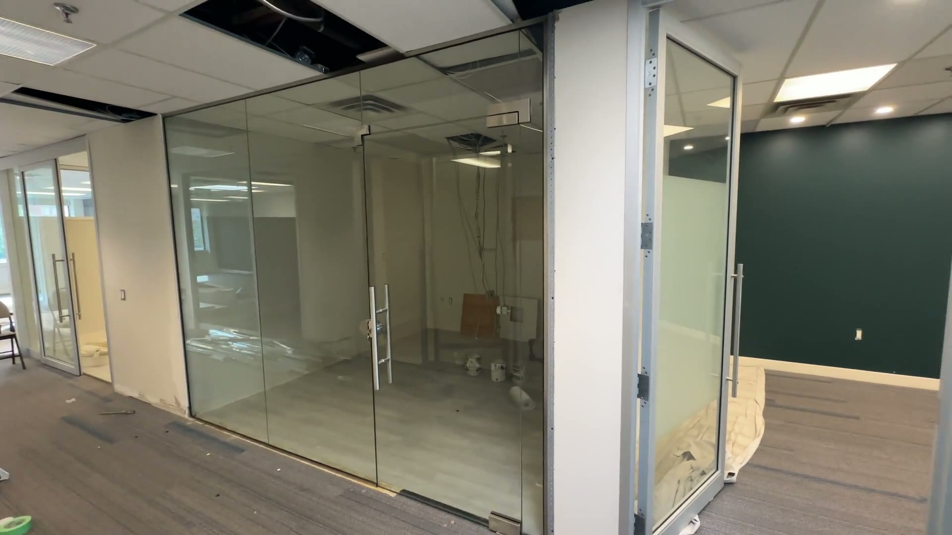 Frameless glass door and partition details along the office corridor