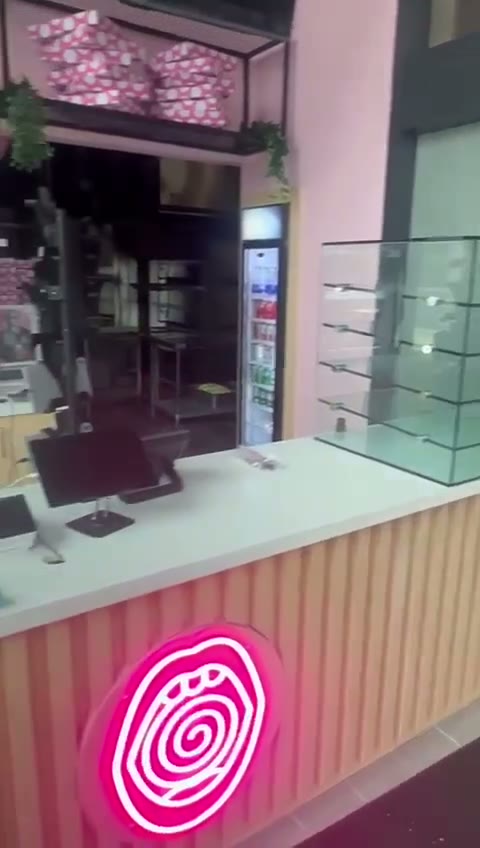 Custom tempered glass retail display case at a storefront counter