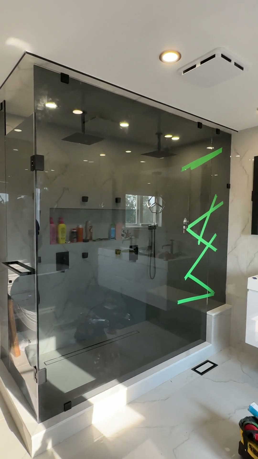 Floor-to-ceiling frameless steam shower with matte black hardware