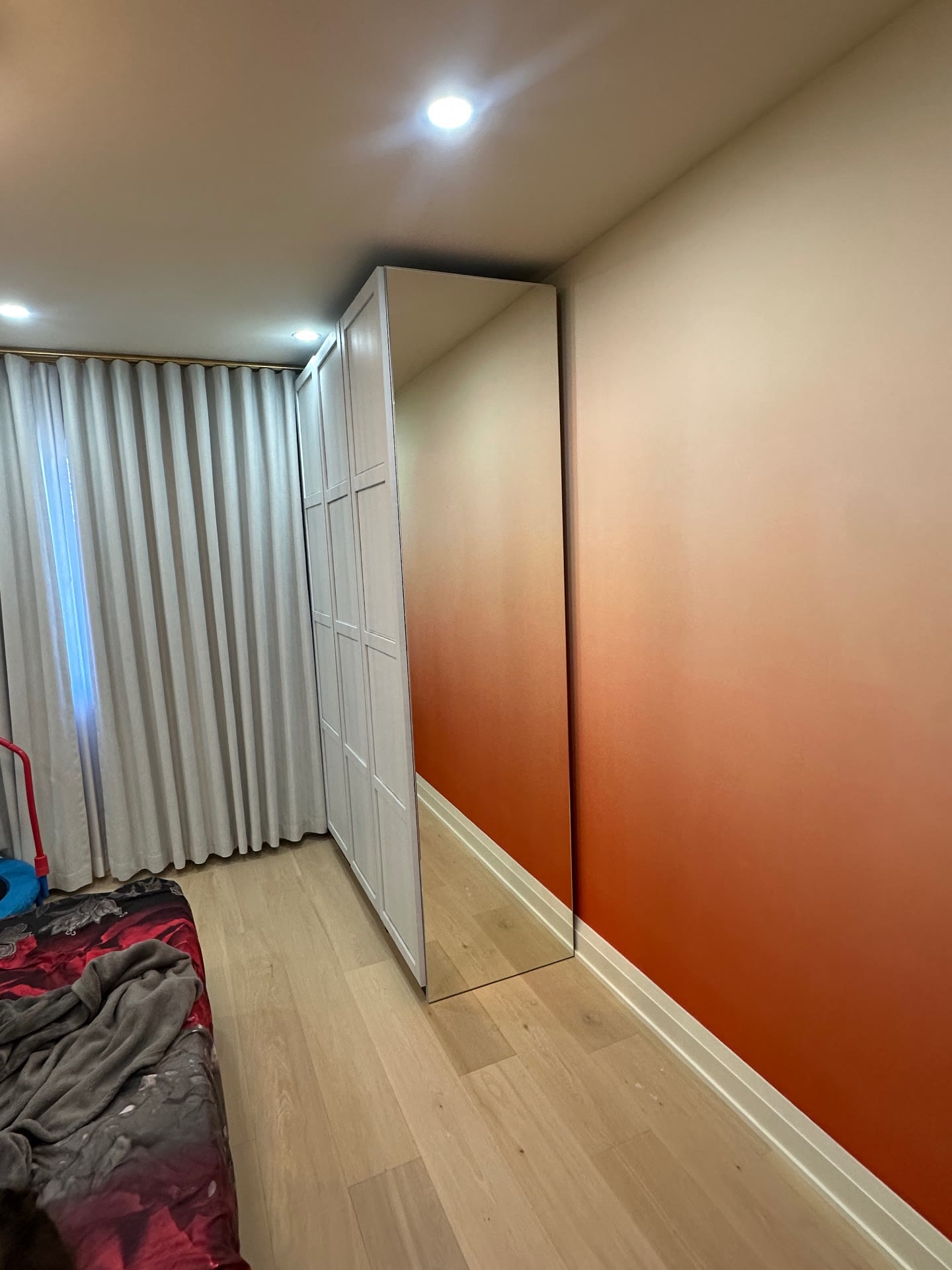 Angled view showing the full-height mirror panel and room reflection