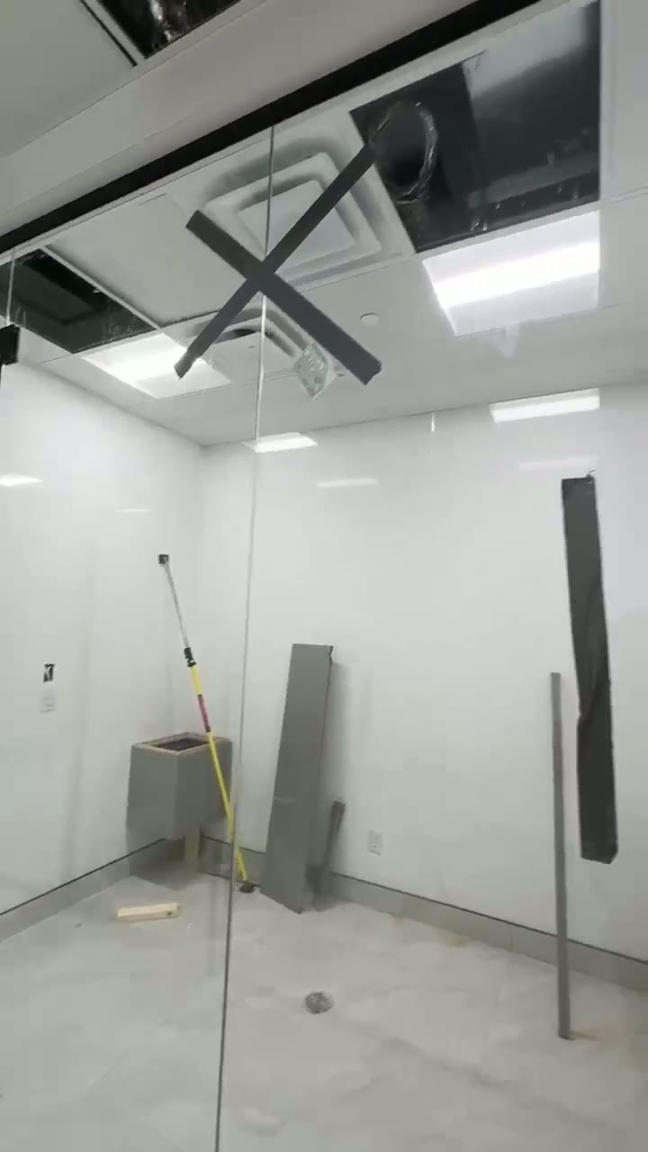 Full-height glass partition enclosing a private office