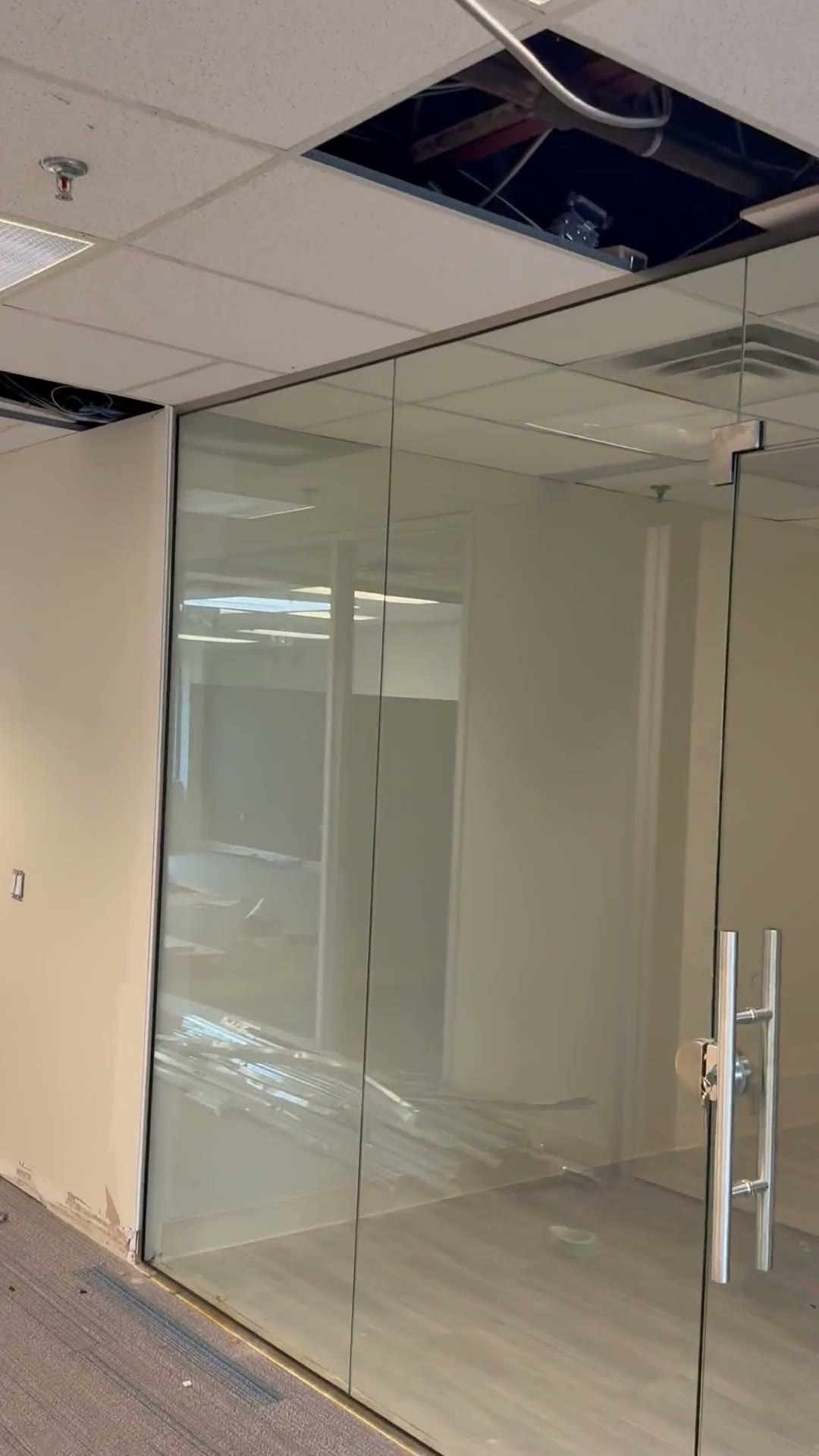 Full-height clear glass offices with frameless swing doors