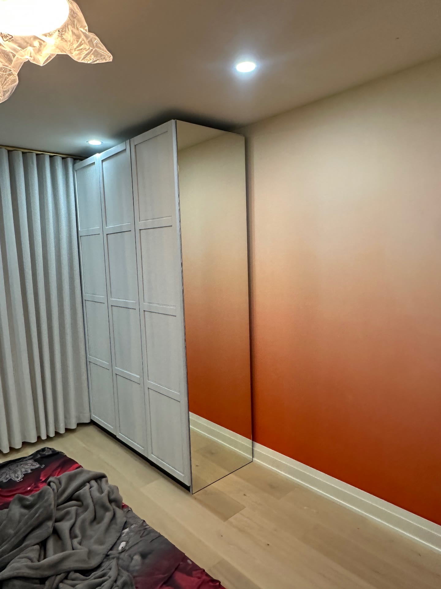 Full-height custom mirror panel fitted to a bedroom wardrobe