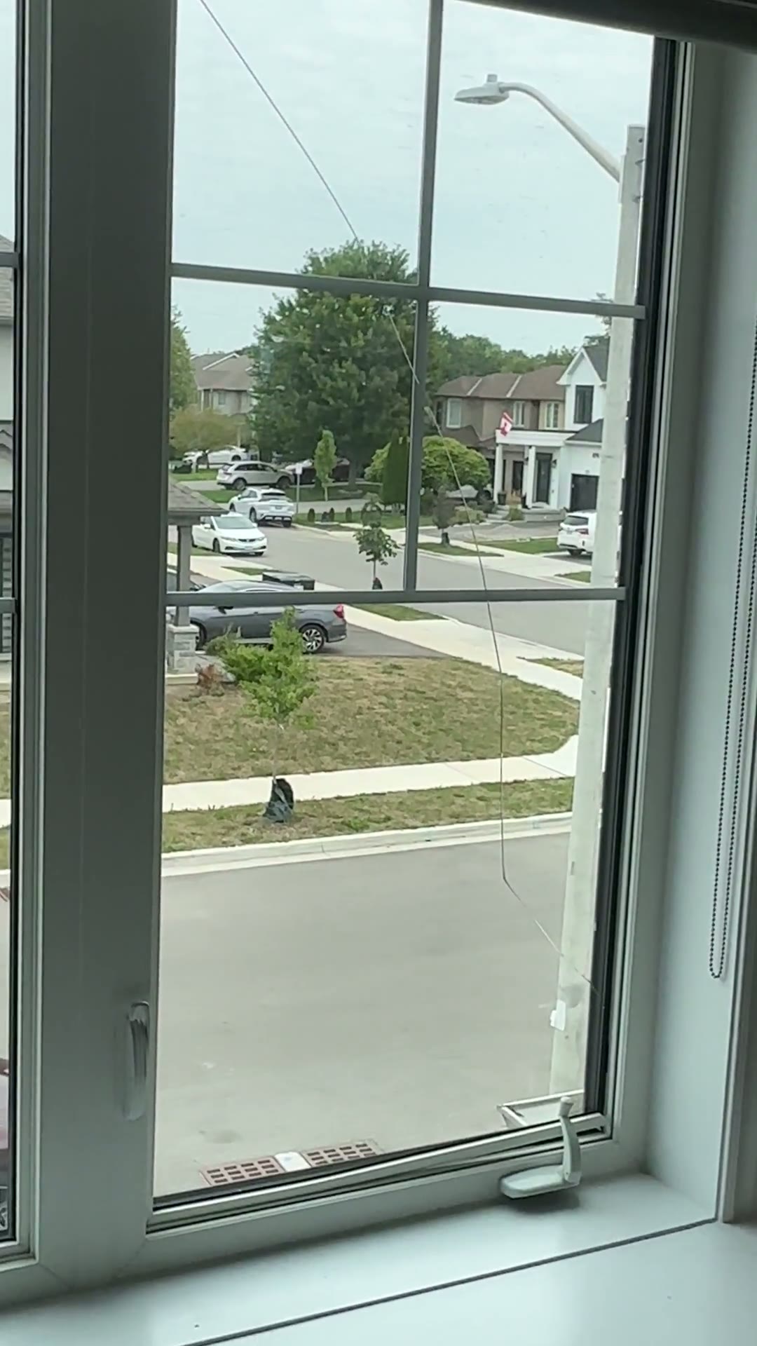 Close inspection of residential casement window glass and hardware